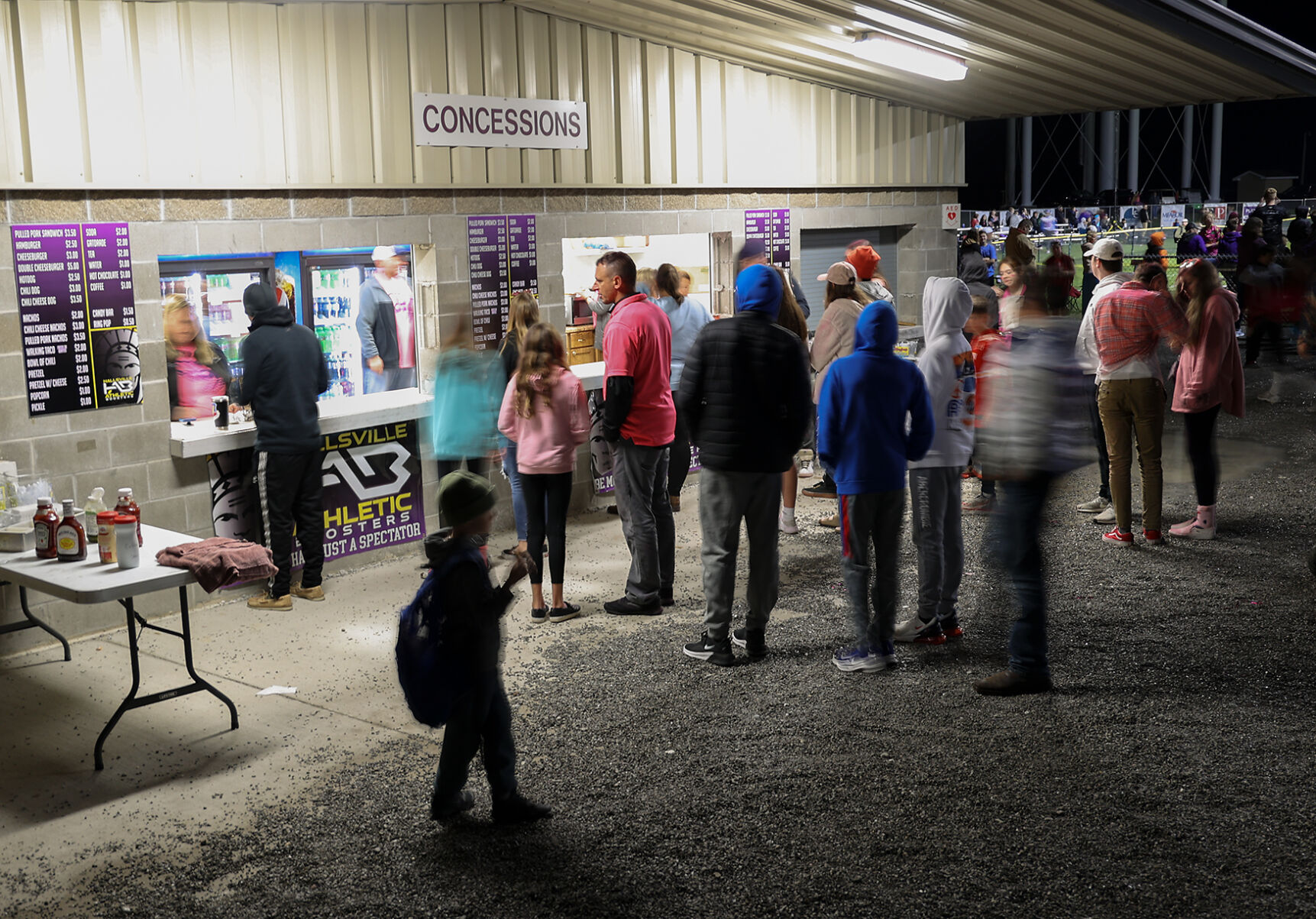 Patrons line up at the concessions stand during halftime
